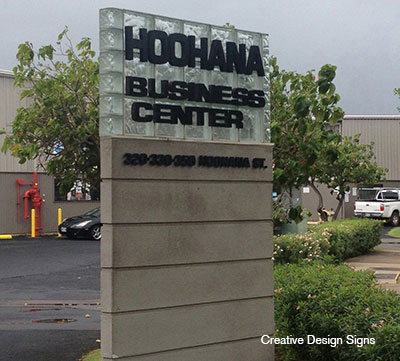 Hoohana Business Center - Glass blocks with HDU letters mounted onto glass blocks with masonry base. Double sided.