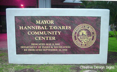 Tavares Center - Granite with gold leaf copy and logo on masonry and stucco wall.