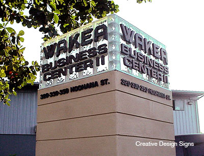 Wakea Business Center II - Glass blocks with HDU letters mounted onto glass blocks with masonry base. Double sided.
